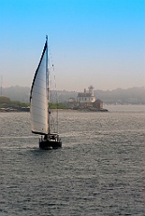 Sailboat Passes Rose Island Lighthouse as Fog Begins to Lift in